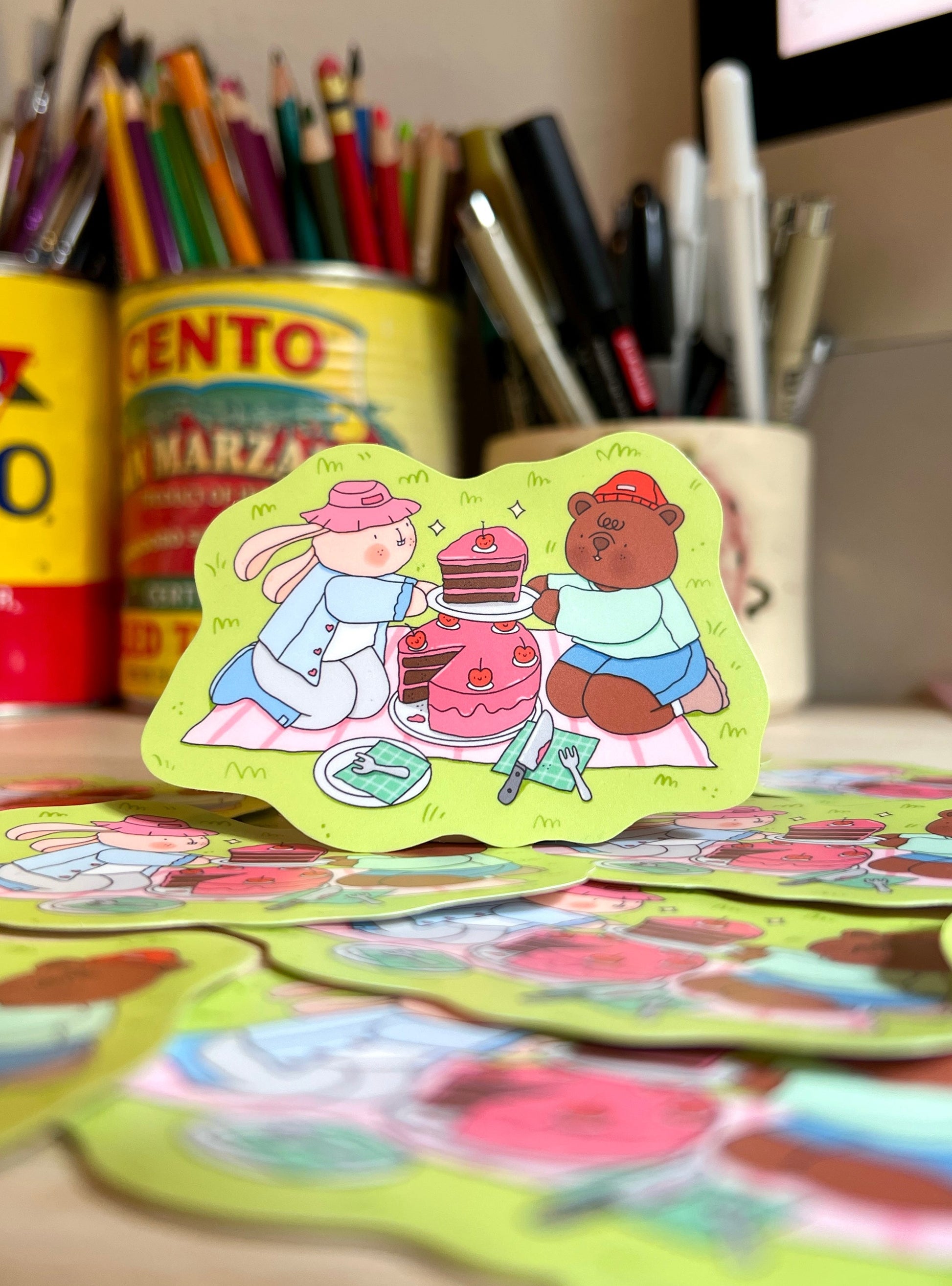 Colorful stickers with cartoon characters on a desk with stationery items.